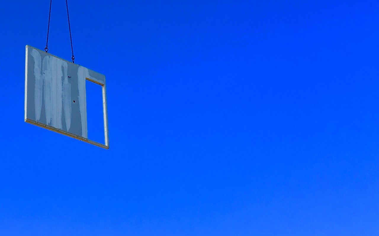 Low angle view of door to heaven against blue sky