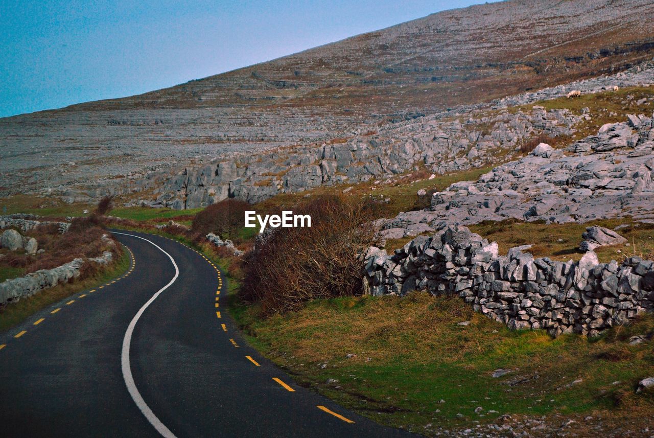 Road amidst landscape against sky