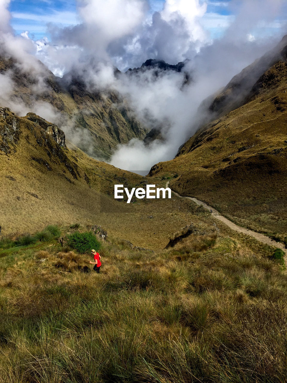 Scenic view of mountains against cloudy sky