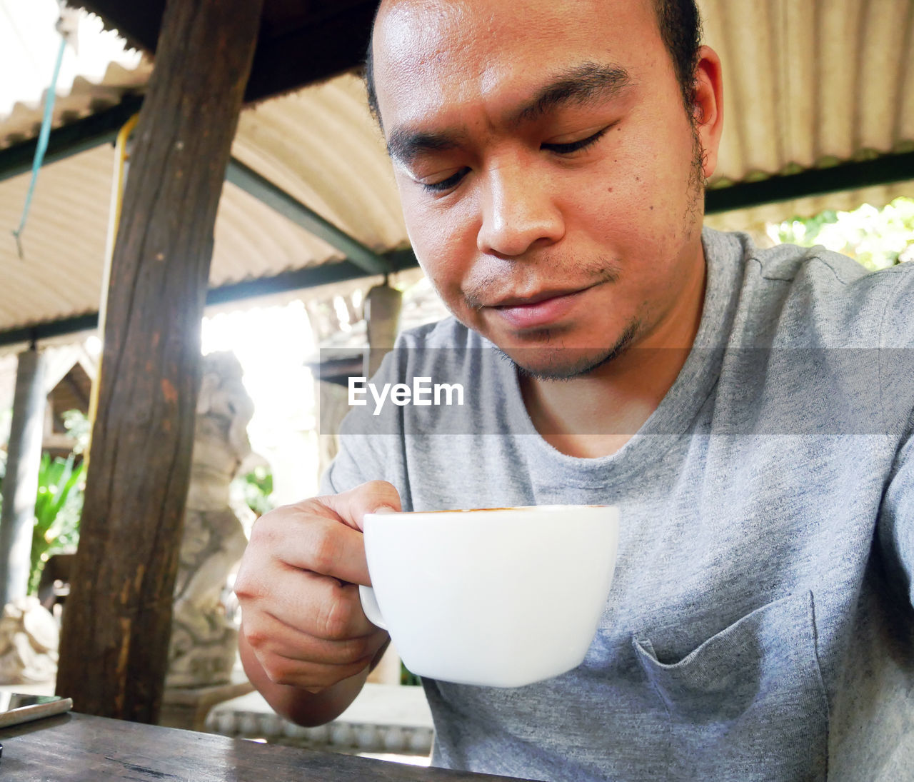 YOUNG MAN DRINKING COFFEE