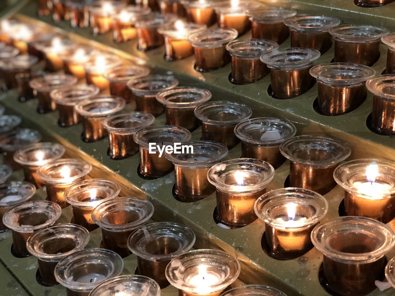 Rows of candles inside of the milan cathedral milan