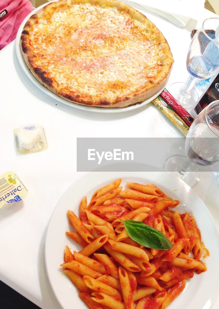 High angle view of pasta and pizza on table