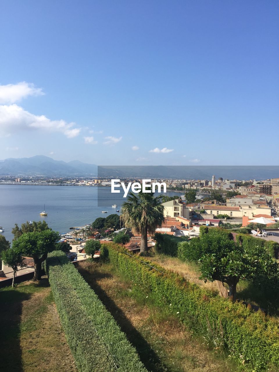 SCENIC VIEW OF SEA AGAINST BUILDINGS IN CITY