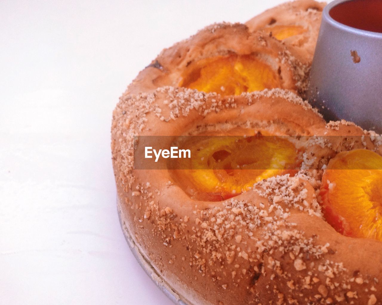 Close-up of apricot cake on white background