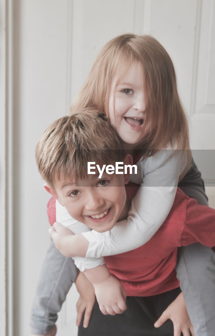 Portrait of playful siblings at home