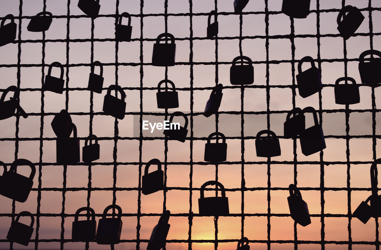 FULL FRAME SHOT OF METAL FENCE AGAINST SKY