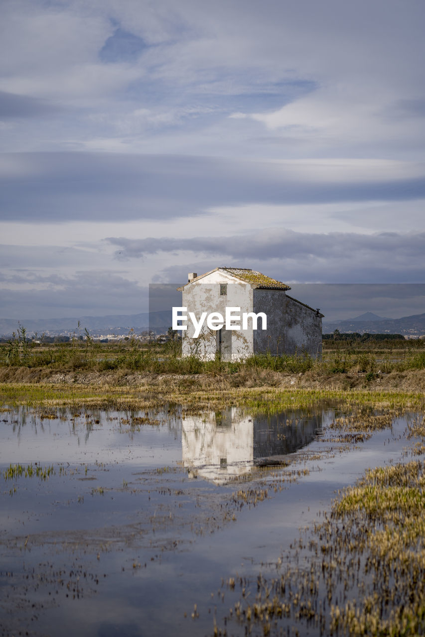 Reflection of a house in the rice fields in spain