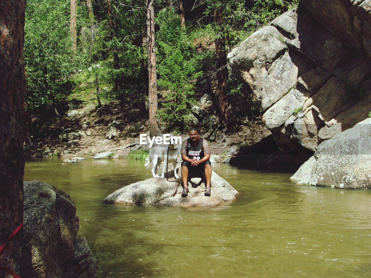 WOMAN SITTING ON ROCKS