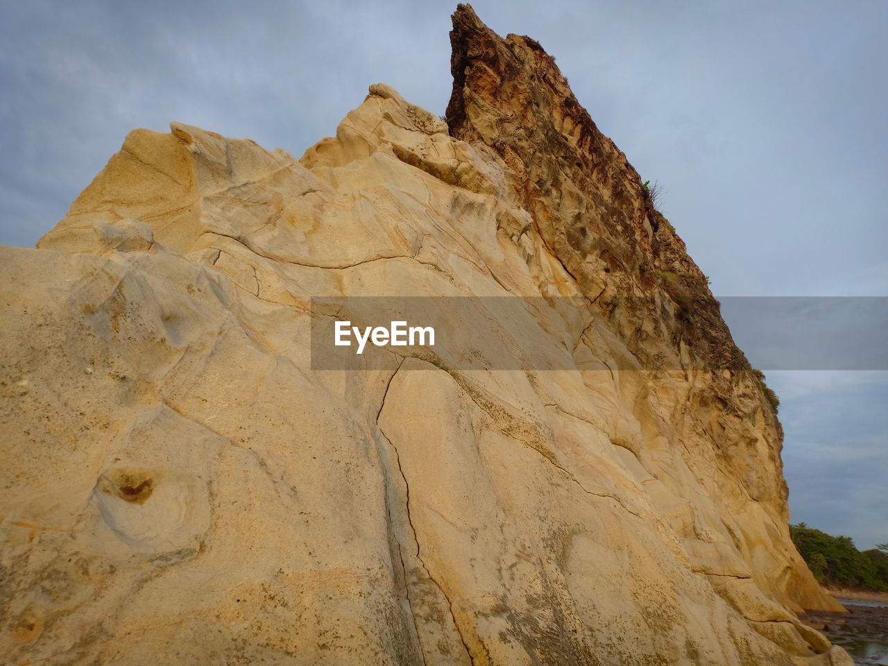 Low angle view of rock formations against sky