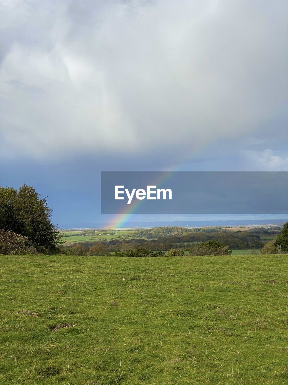 SCENIC VIEW OF RAINBOW OVER FIELD