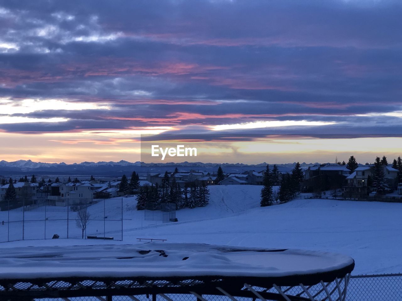 Scenic view of snowcapped mountains against sky during sunset