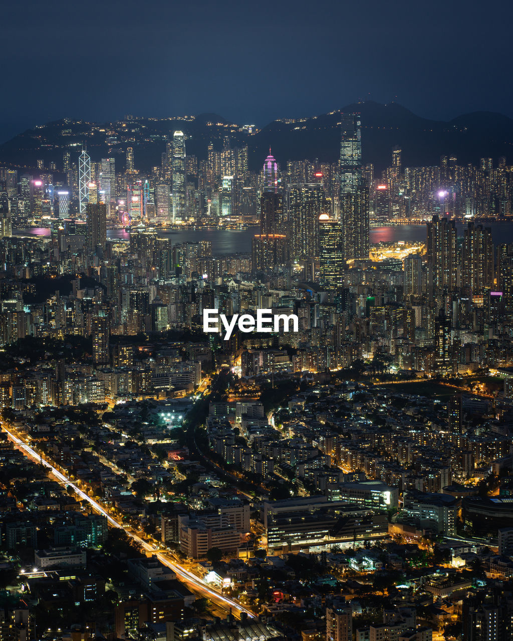 HIGH ANGLE VIEW OF ILLUMINATED CITYSCAPE AGAINST SKY AT NIGHT