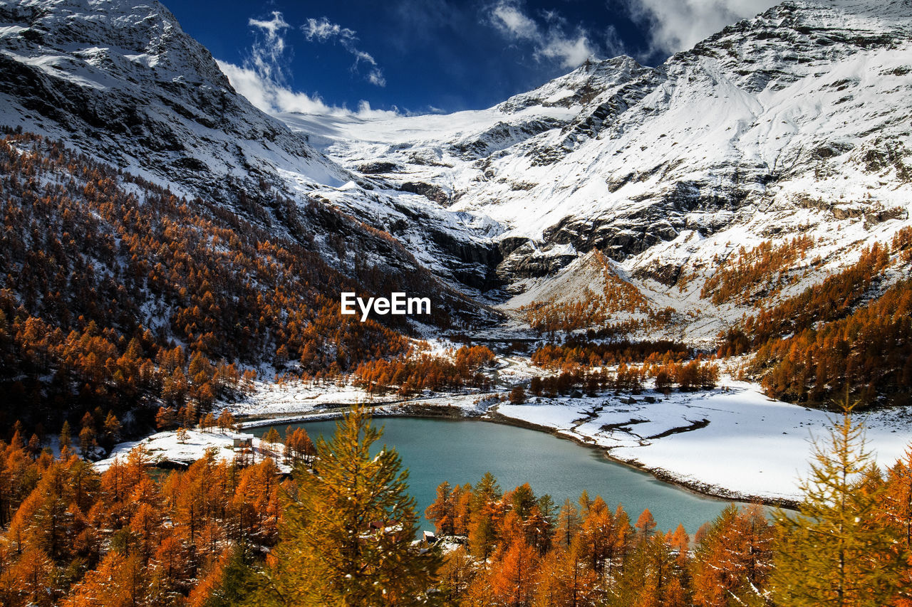 Scenic view of snowcapped mountains and lake during autumn