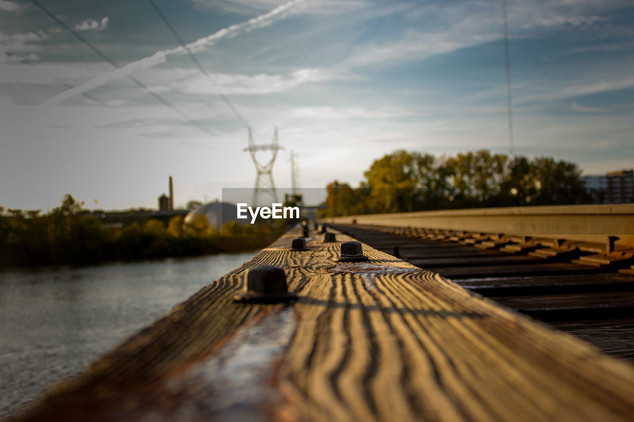 Close-up of railroad track against sky during sunset