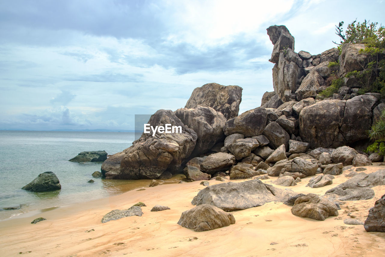 Rocks on beach against sky