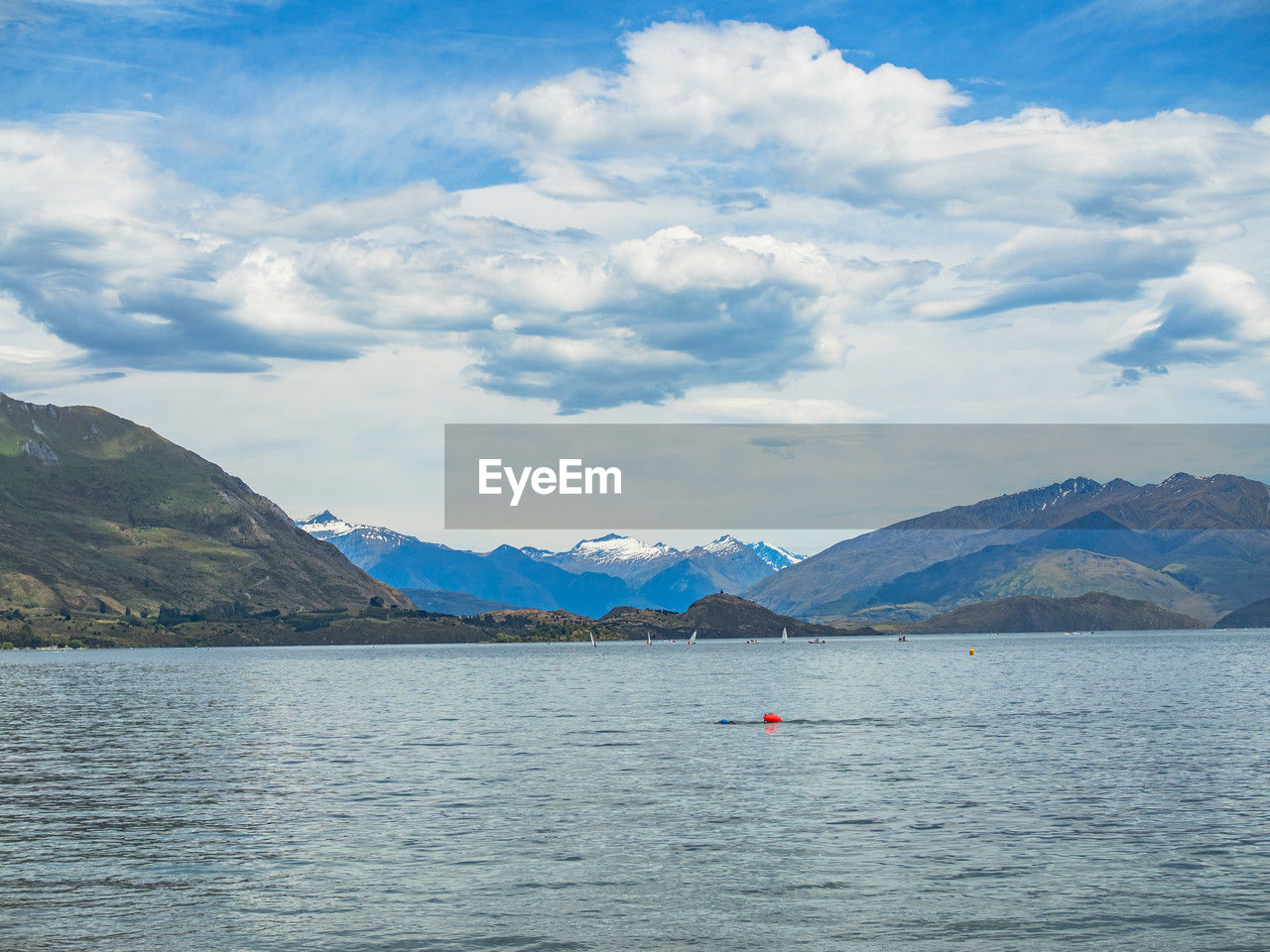 mountain, water, sky, scenics - nature, cloud, mountain range, beauty in nature, lake, nature, environment, landscape, travel, tranquil scene, travel destinations, tranquility, no people, day, blue, reservoir, land, transportation, outdoors, body of water, vehicle, trip, nautical vessel, tourism, vacation, holiday, bay, non-urban scene, idyllic