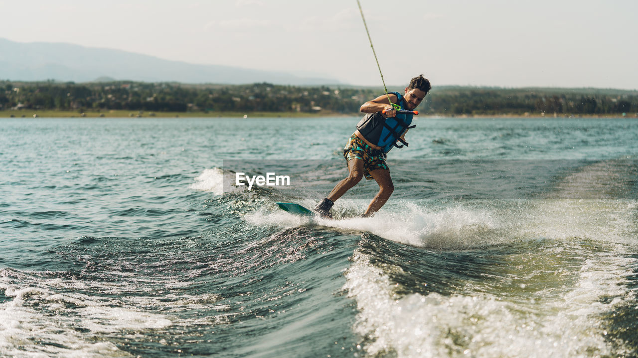 Full length of man doing wakeboard in a lake