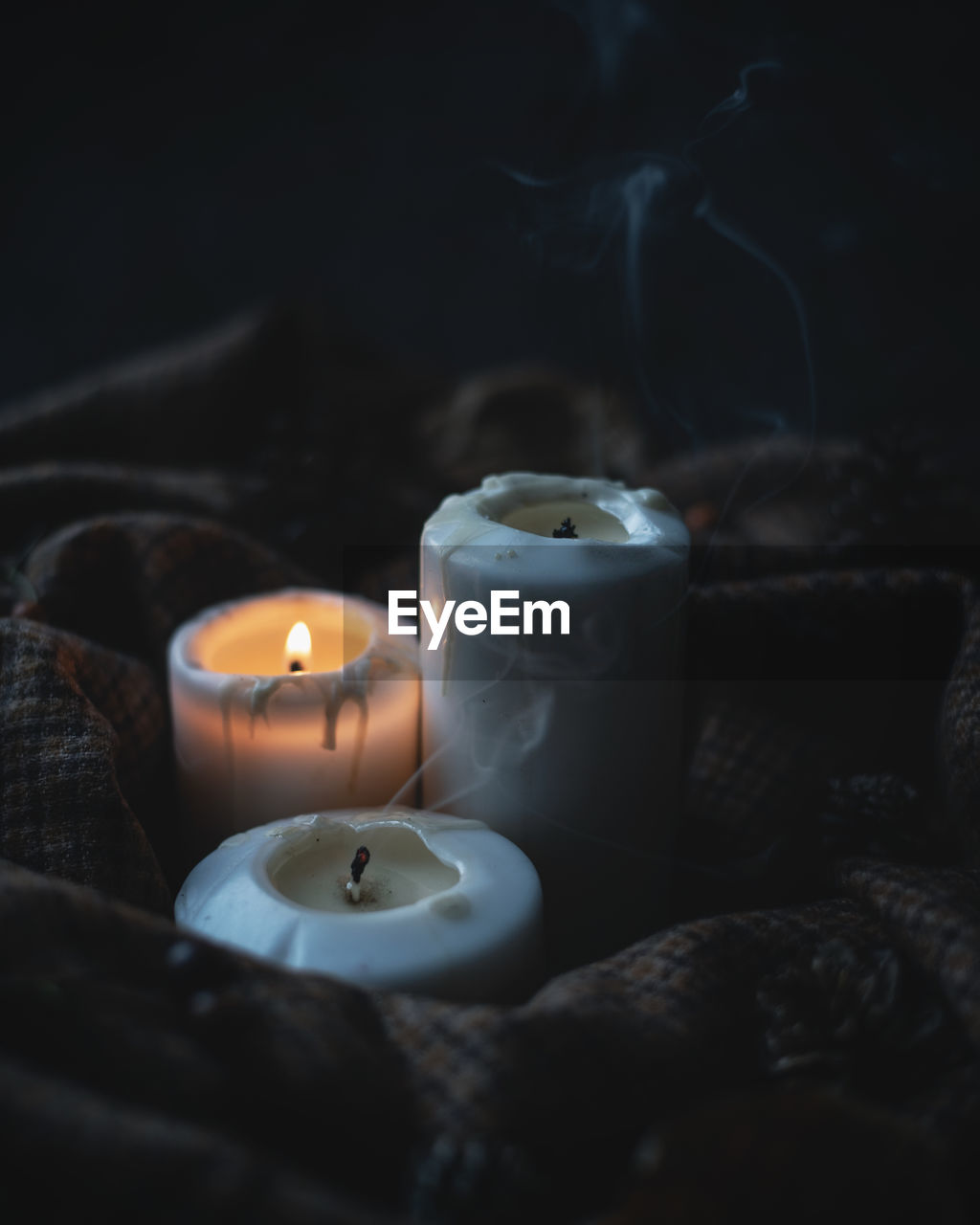 High angle view of lit candles on table