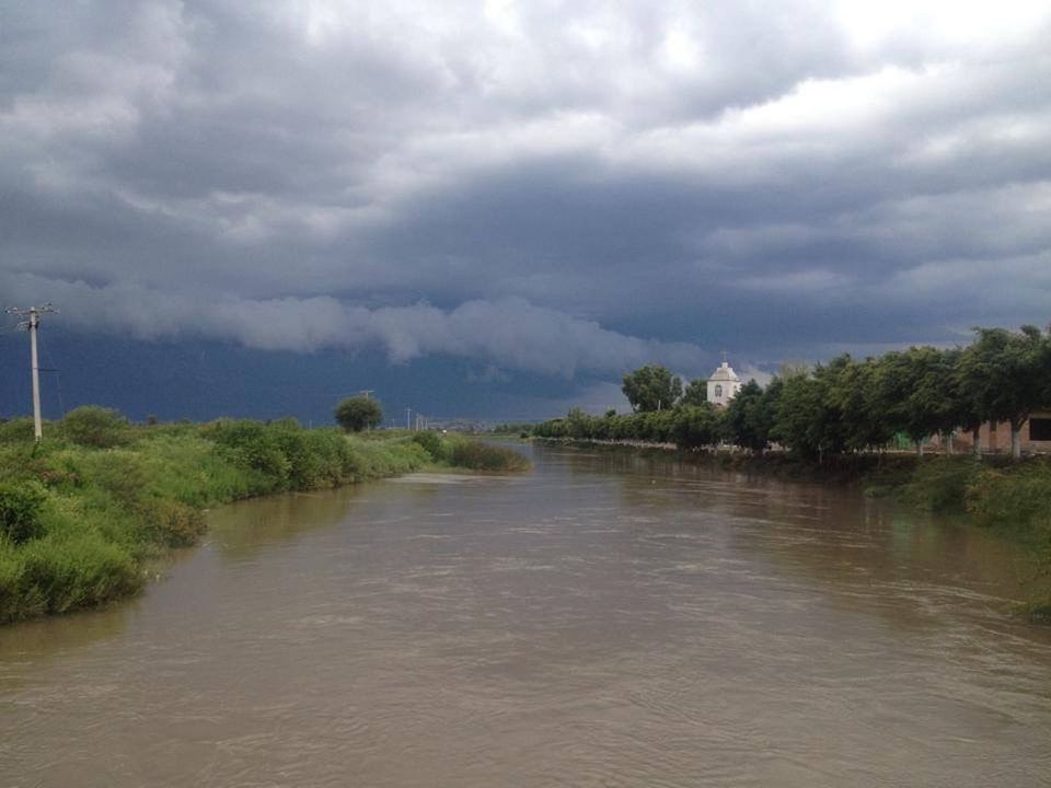 VIEW OF RIVER AGAINST CLOUDY SKY