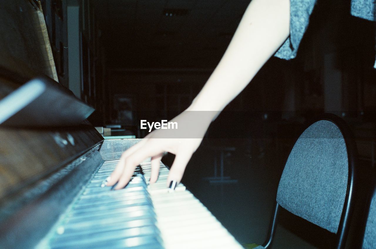 Woman's hand playing the piano, shot on film