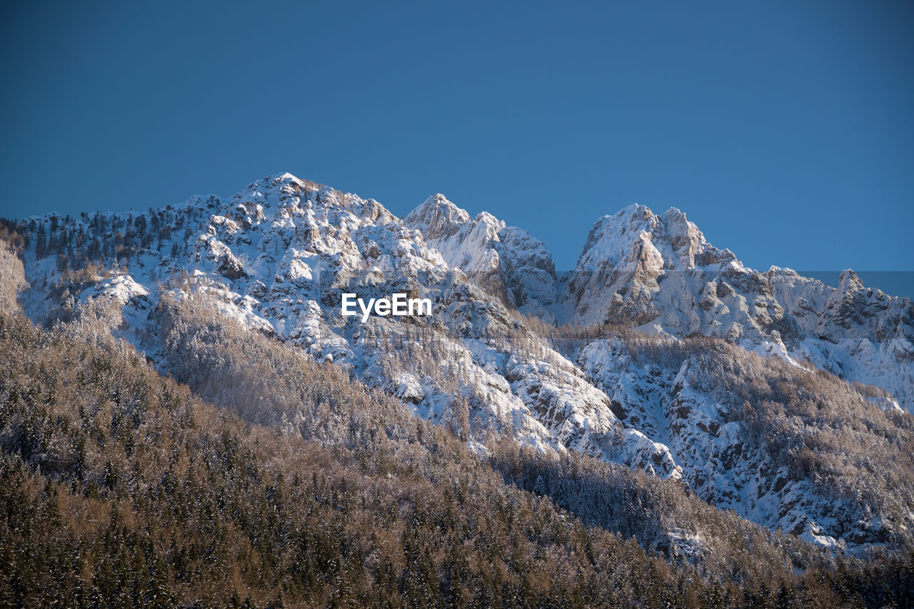 SNOWCAPPED MOUNTAINS AGAINST CLEAR BLUE SKY