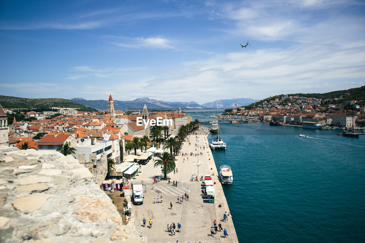 High angle view of townscape by sea against sky