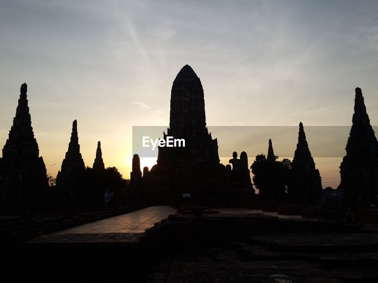 Silhouette wat chaiwattanaram against sky during sunset