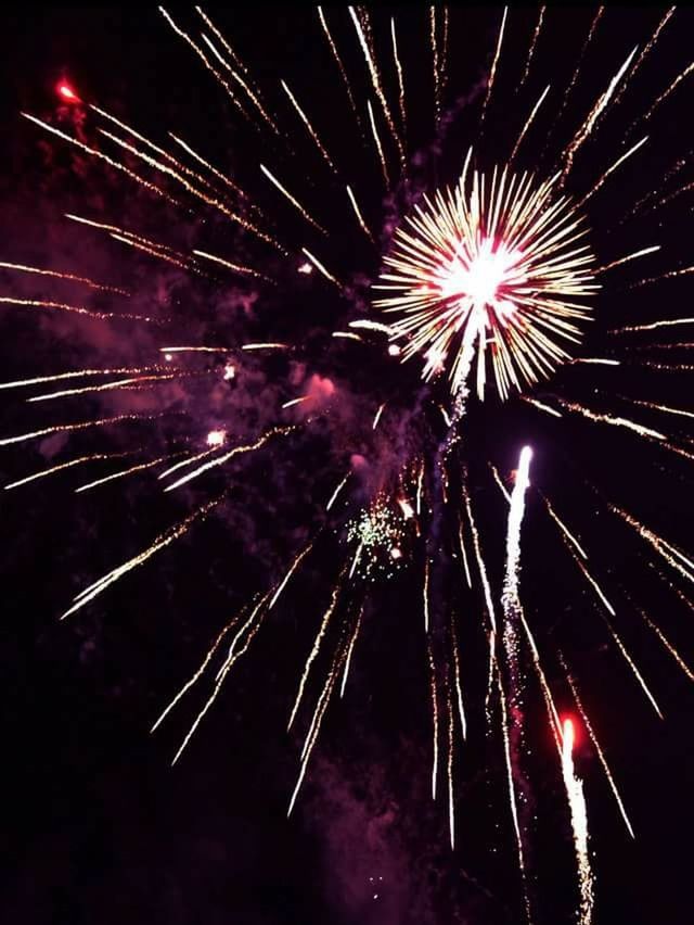 LOW ANGLE VIEW OF FIREWORKS DISPLAY