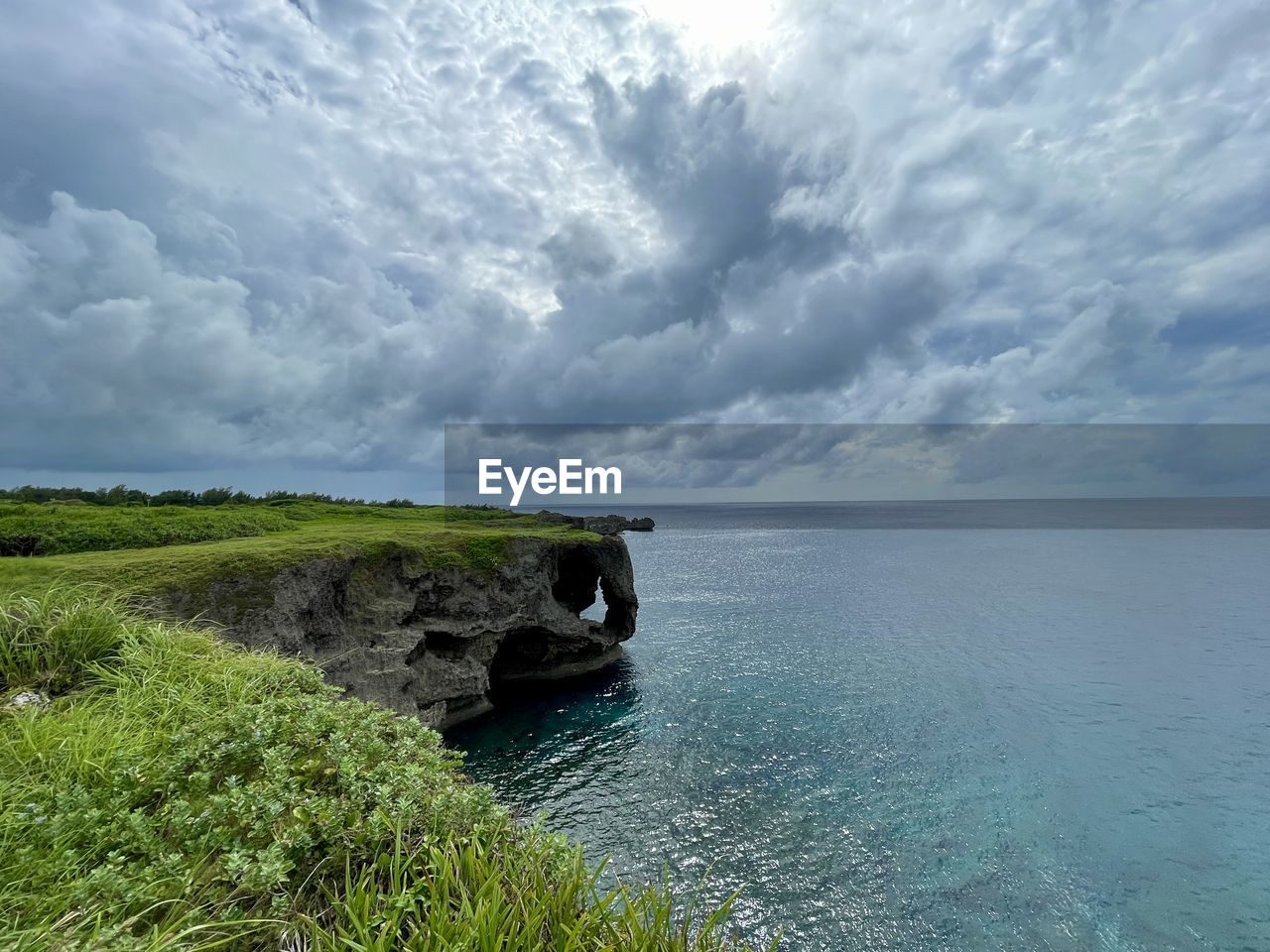 water, sky, cloud, sea, coast, scenics - nature, beauty in nature, horizon, shore, land, nature, ocean, environment, beach, body of water, landscape, bay, tranquility, horizon over water, tranquil scene, travel destinations, coastline, plant, no people, travel, cliff, outdoors, day, grass, cloudscape, tourism, idyllic, non-urban scene, blue, seascape, terrain, rock, island, trip