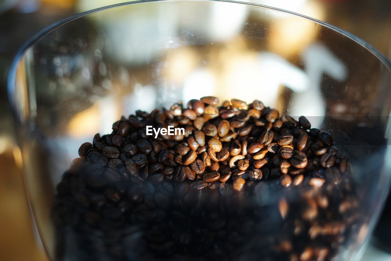 CLOSE-UP OF COFFEE BEANS IN GLASS CONTAINER