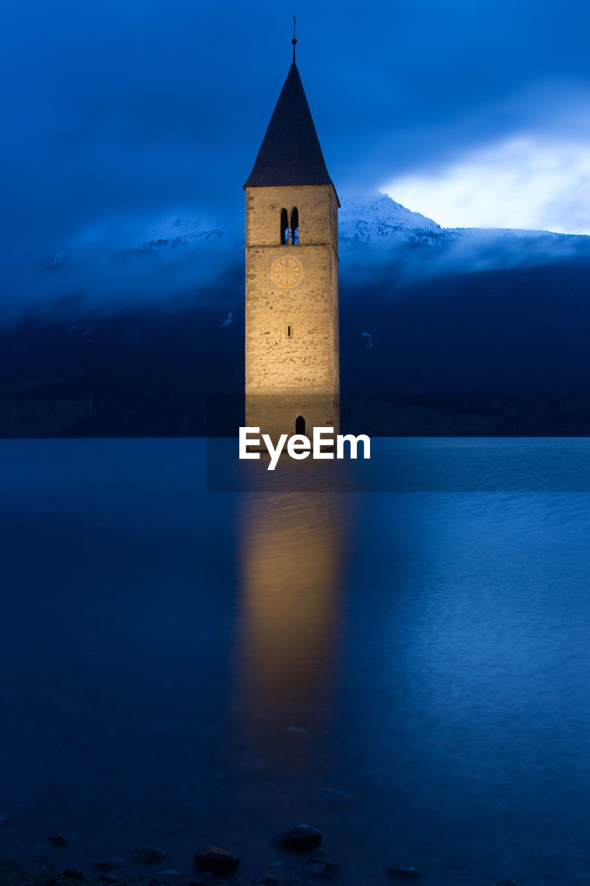 Bell tower in sea at night