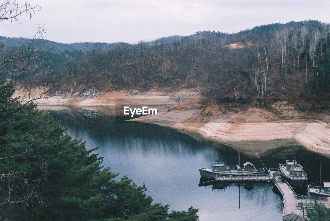 High angle view of dam by lake against sky