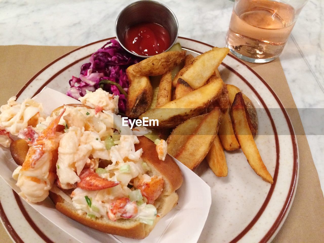 High angle view of lobster roll with french fries served on table