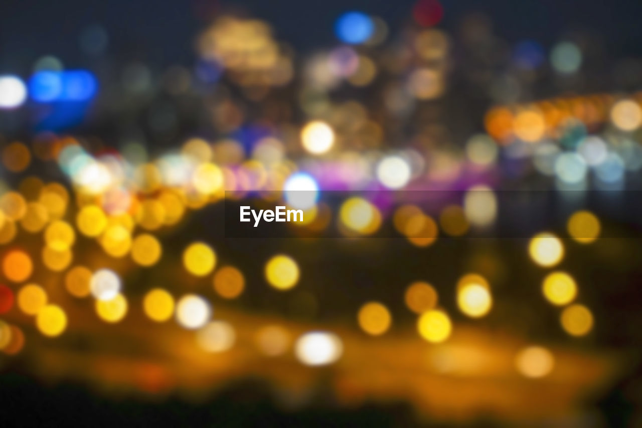 DEFOCUSED IMAGE OF ILLUMINATED CITY