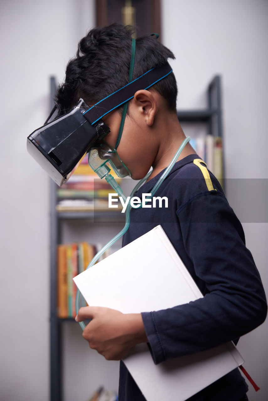 Side view of boy wearing virtual reality simulator