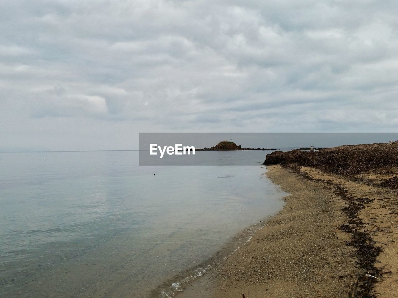 VIEW OF SEA AGAINST CLOUDY SKY