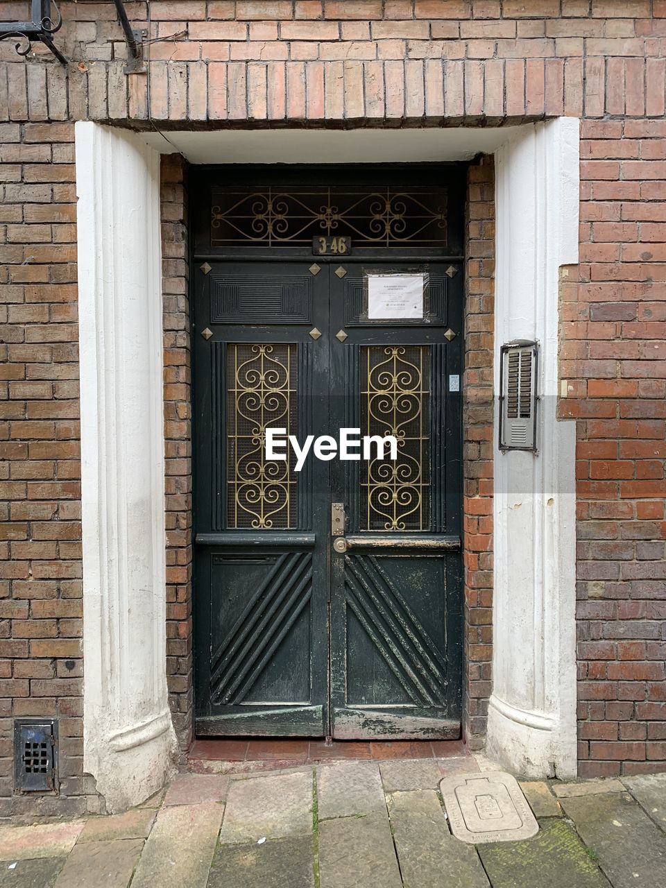 architecture, built structure, building exterior, no people, wall, wood, facade, text, iron, day, entrance, communication, wall - building feature, door, brick, building, house, closed, outdoors, urban area, brick wall