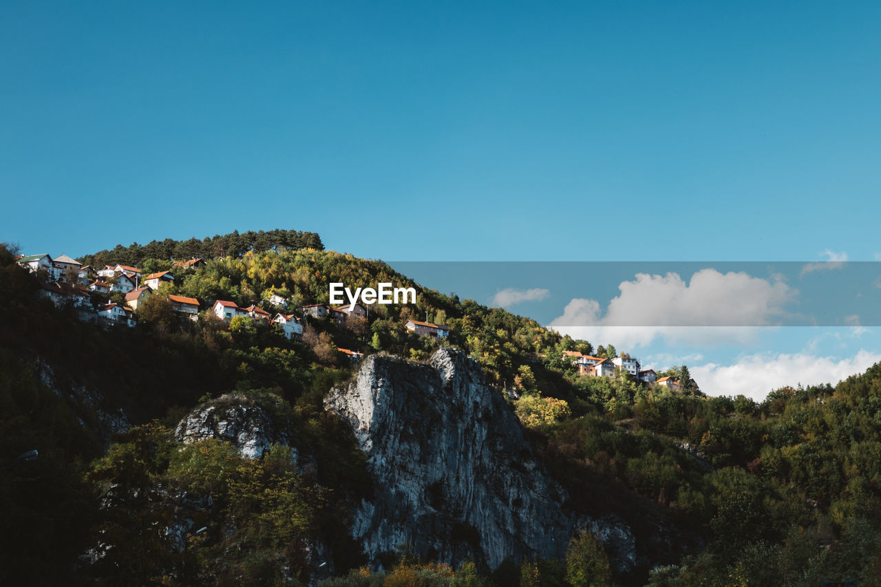 Scenic view of mountains against blue sky