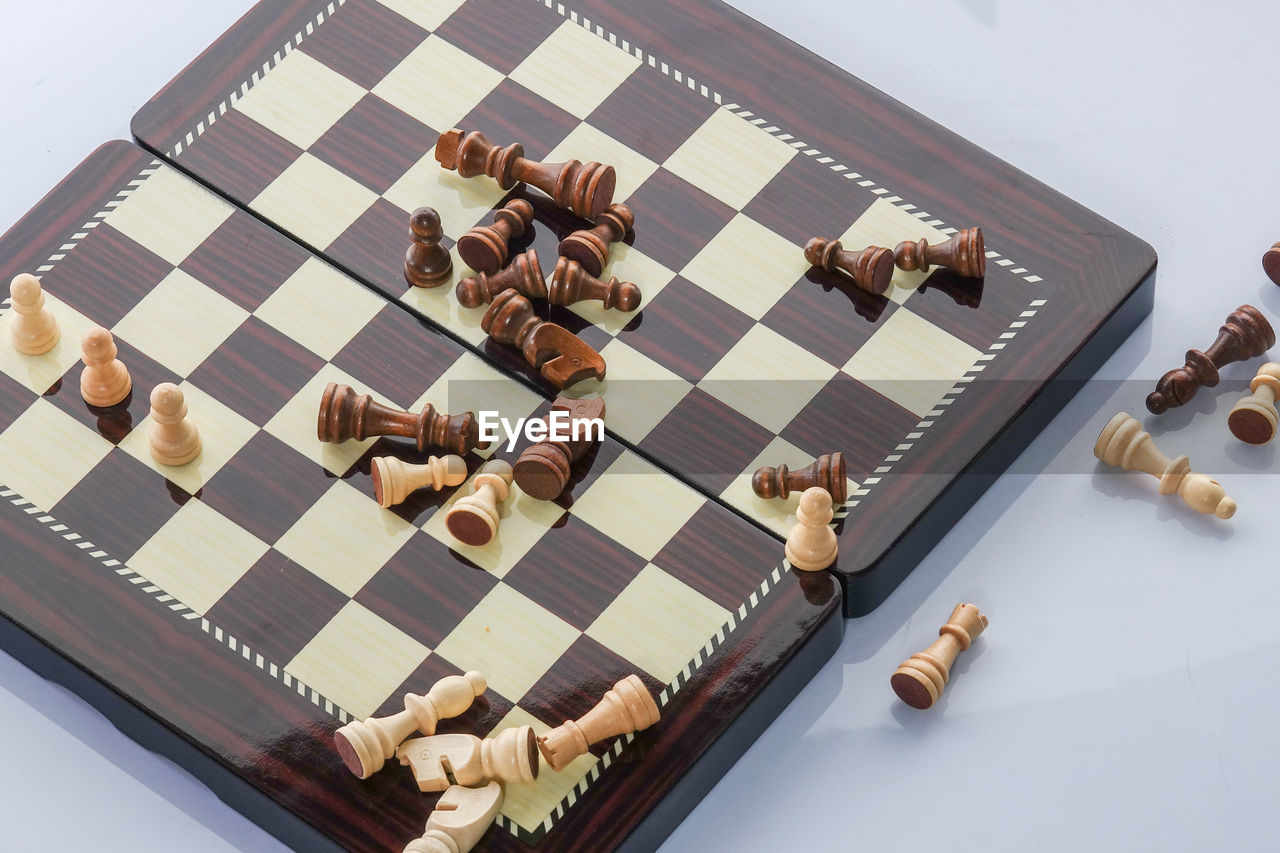 High angle view of chess board over white background