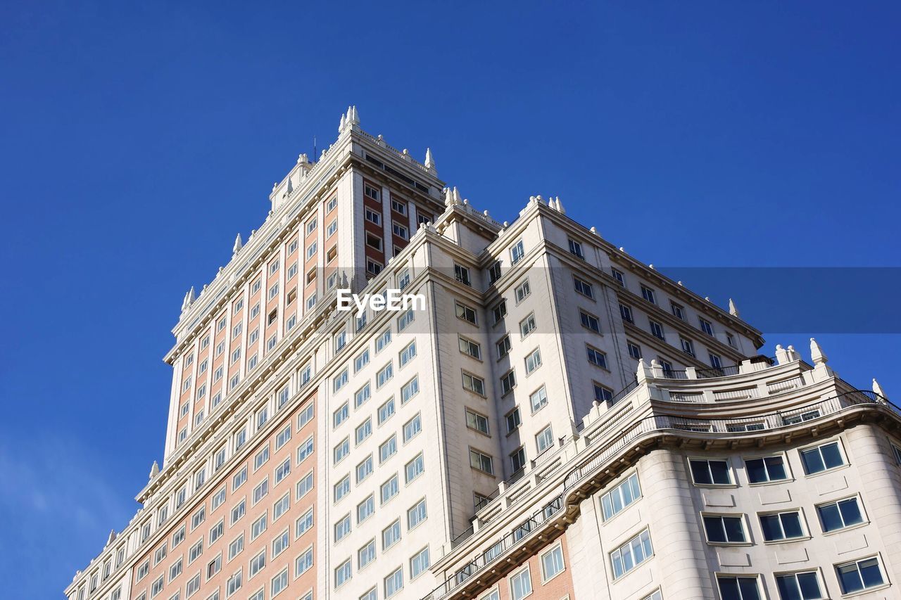 Low angle view of building against blue sky