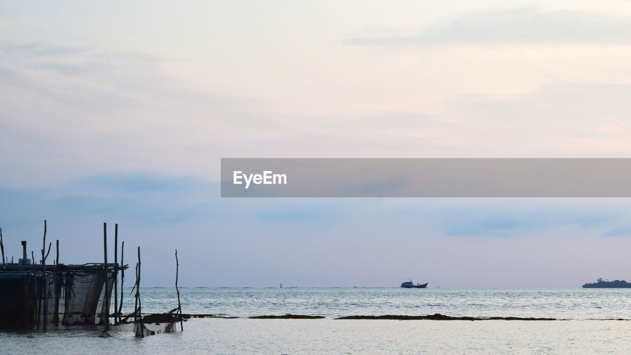 View of calm sea against cloudy sky