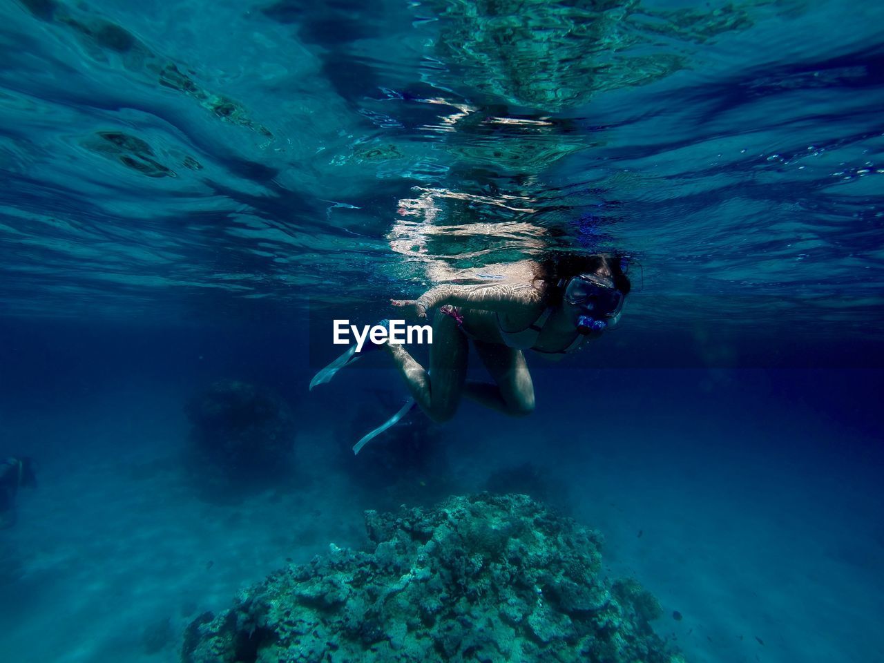 Young woman snorkeling undersea