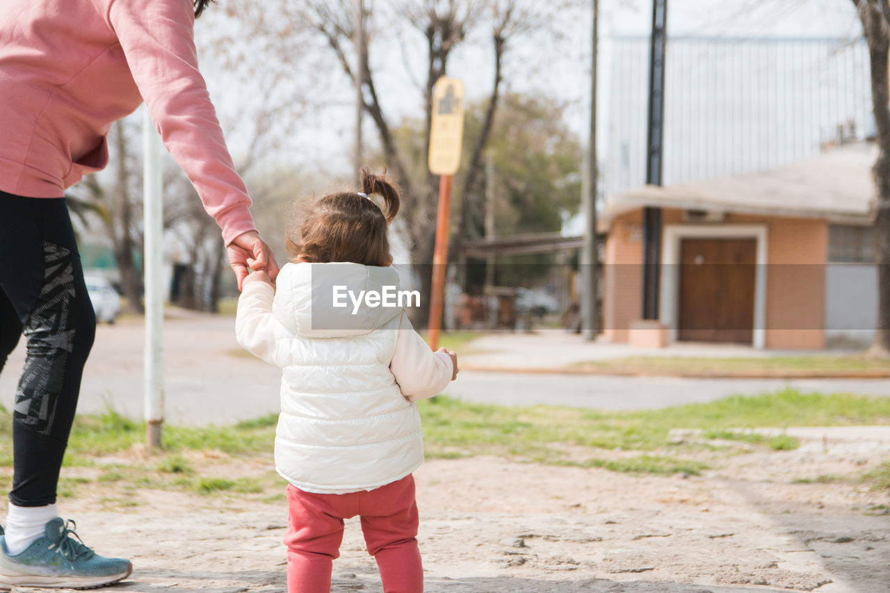 Mother and daughter walking outdoors