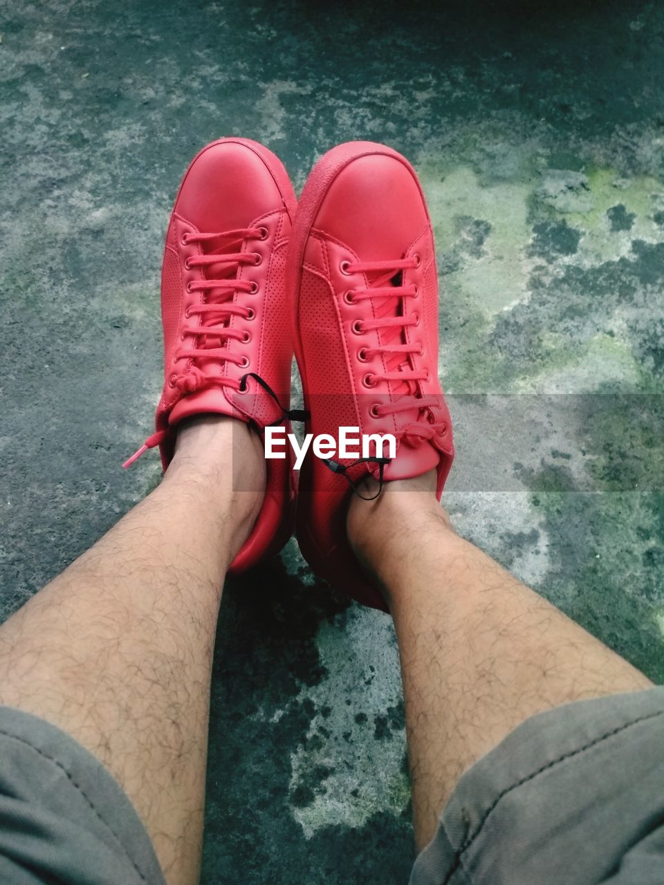 Low section of man wearing red shoes