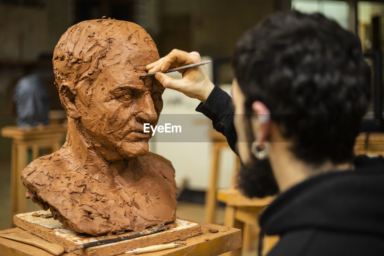 Sculptor finishing a clay head