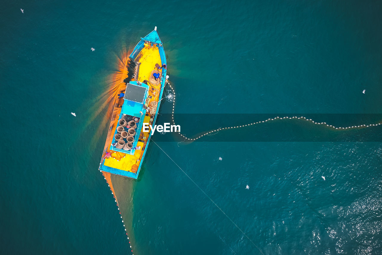 High angle view of ferris wheel in sea