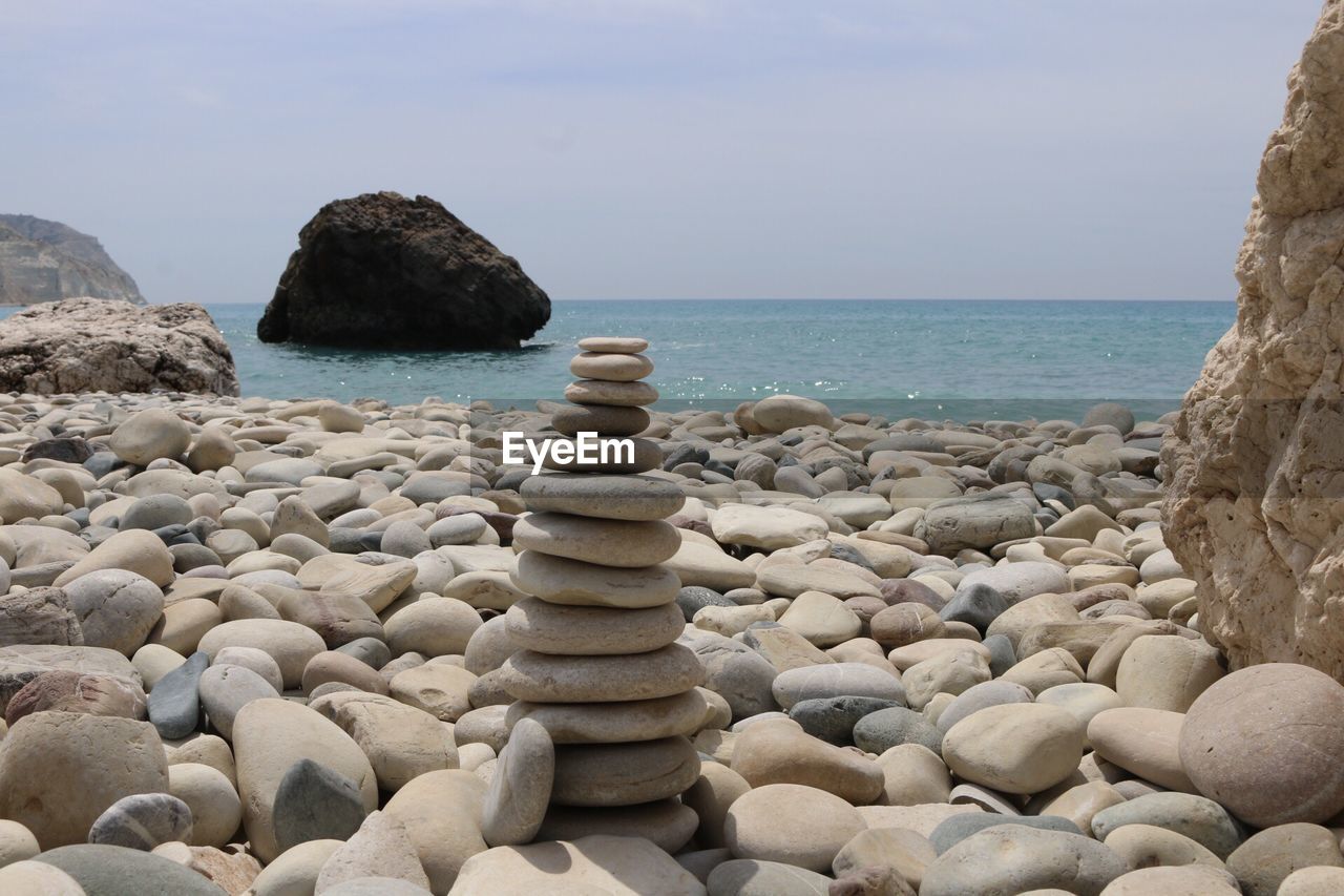 Rocks by sea against sky