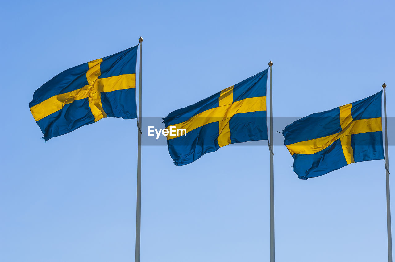 Flag of sweden against blue sky