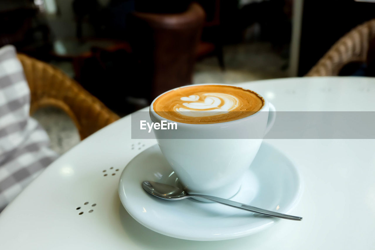 CLOSE-UP OF COFFEE CUP ON TABLE