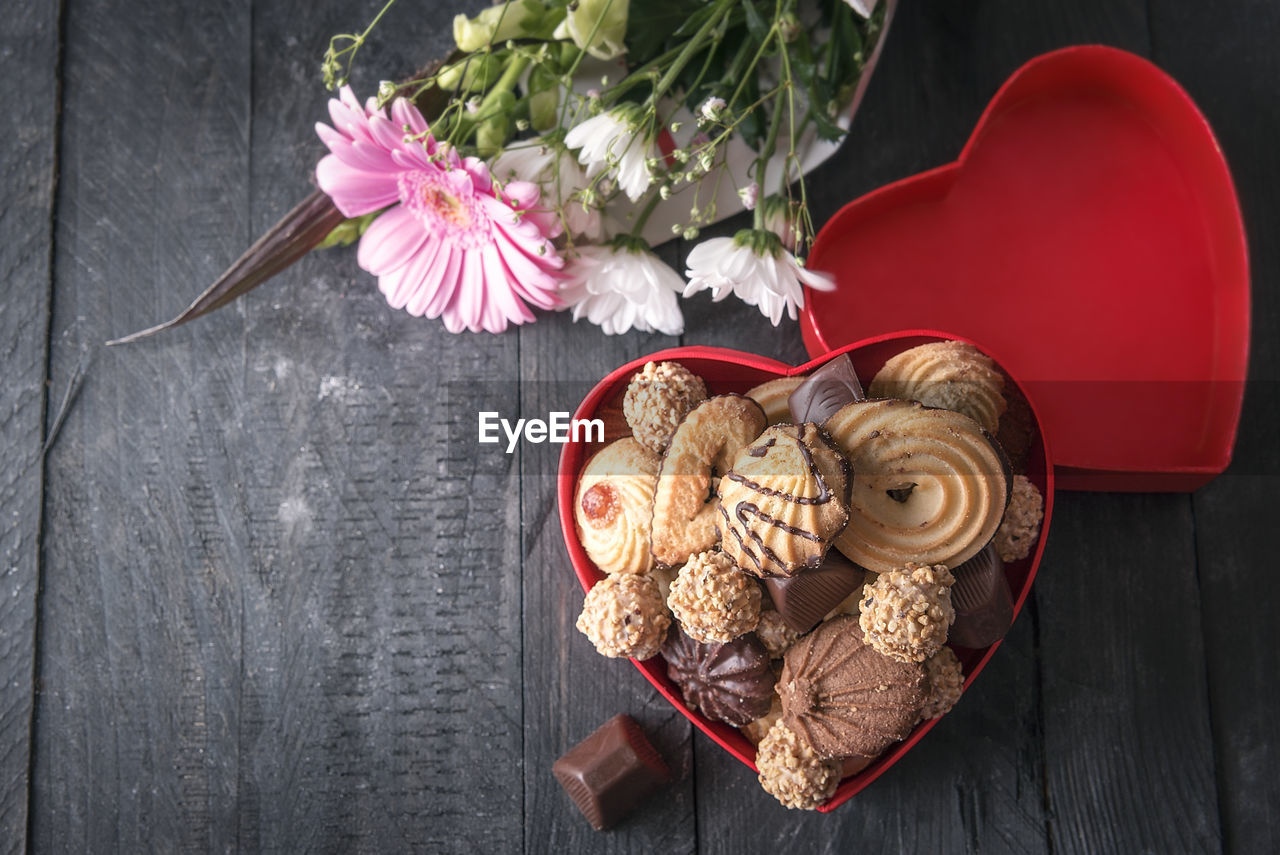 Directly above shot of cookies in heart shape container on table